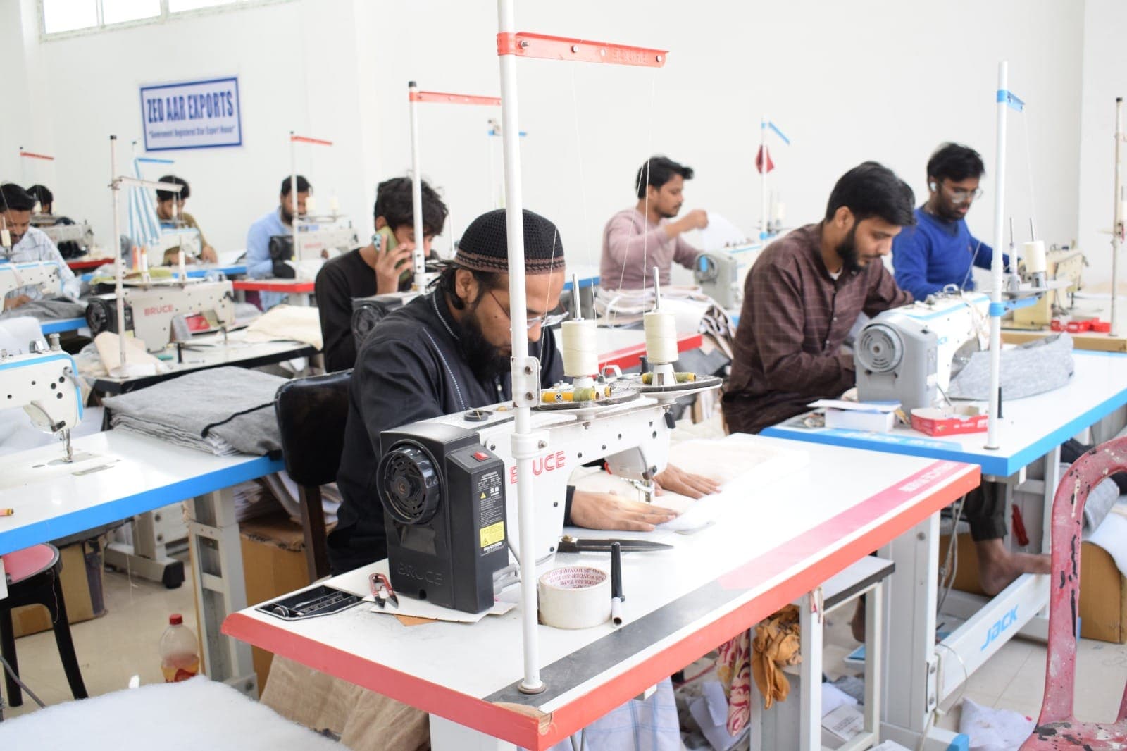 Artisan operating an industrial sewing machine at Zed Aar Exports